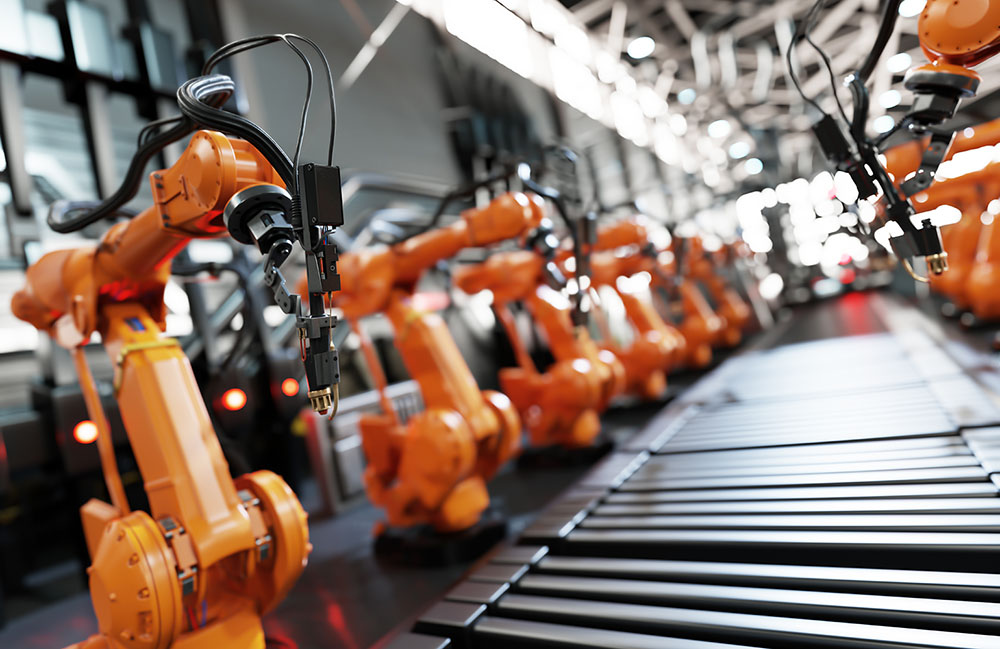 Orange robotic arms working on a manufacturing line. The ARM Institute has put out a call for projects to improve submarine construction.