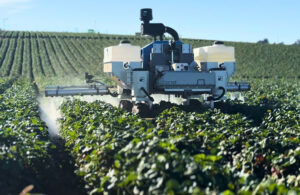 amiga flex in a field spraying crops.